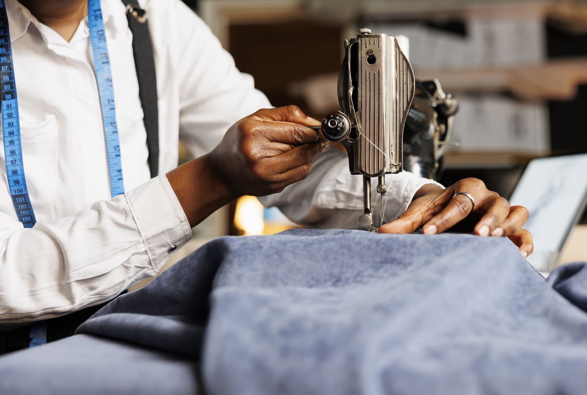 Tailoring expert adjusting fabric on a sewing machine, showcasing professional alterations service at Best Cleaners NY.